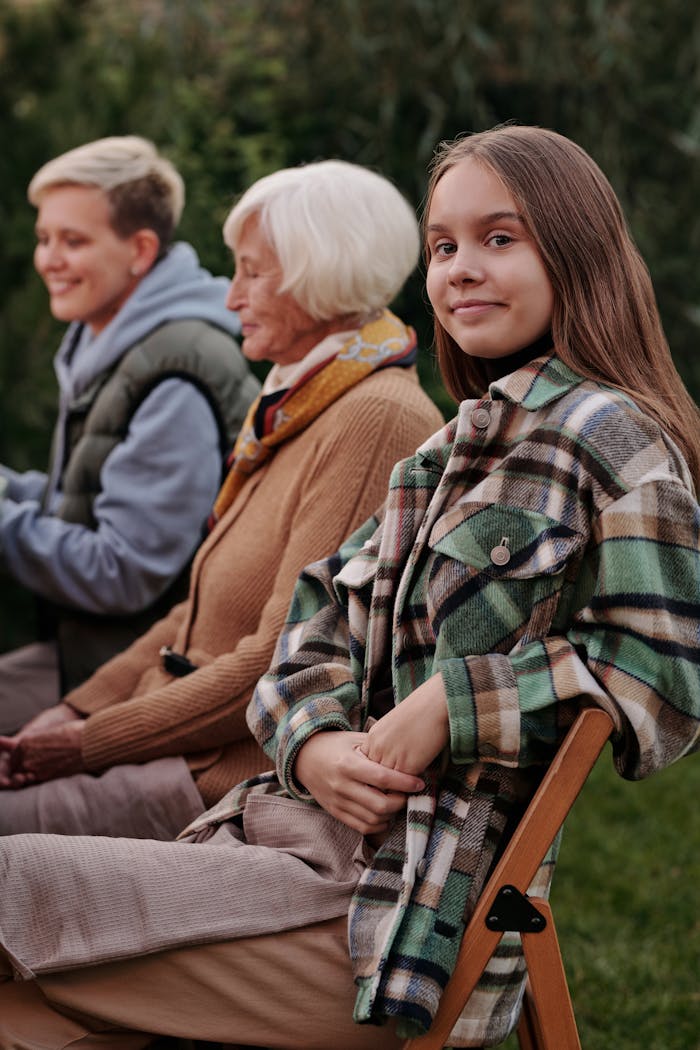 Three generations enjoying a relaxing outdoor gathering, showcasing family bonds.